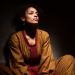 marciadovales_a_woman_seated_in_silence_her_shadow_behind_her_s_0199e4ab-c95b-40af-af7f-79725396dd36
