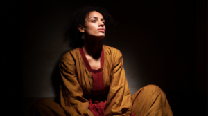 marciadovales_a_woman_seated_in_silence_her_shadow_behind_her_s_0199e4ab-c95b-40af-af7f-79725396dd36